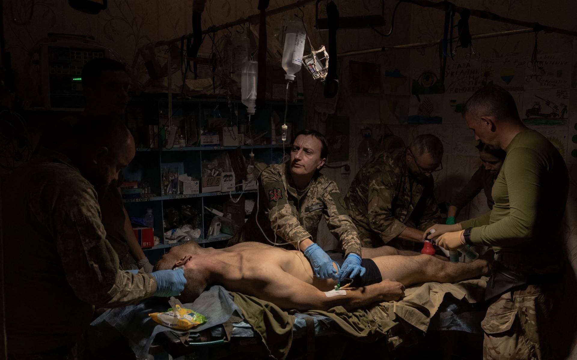 A wounded Ukrainian soldier is treated by Ukrainian military medics in a stabilization point in an undisclosed location near Bakhmut