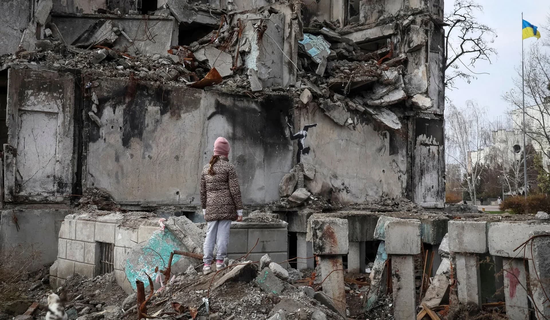 A work of graffiti artist Banksy at the wall of destroyed building in the town of Borodianka