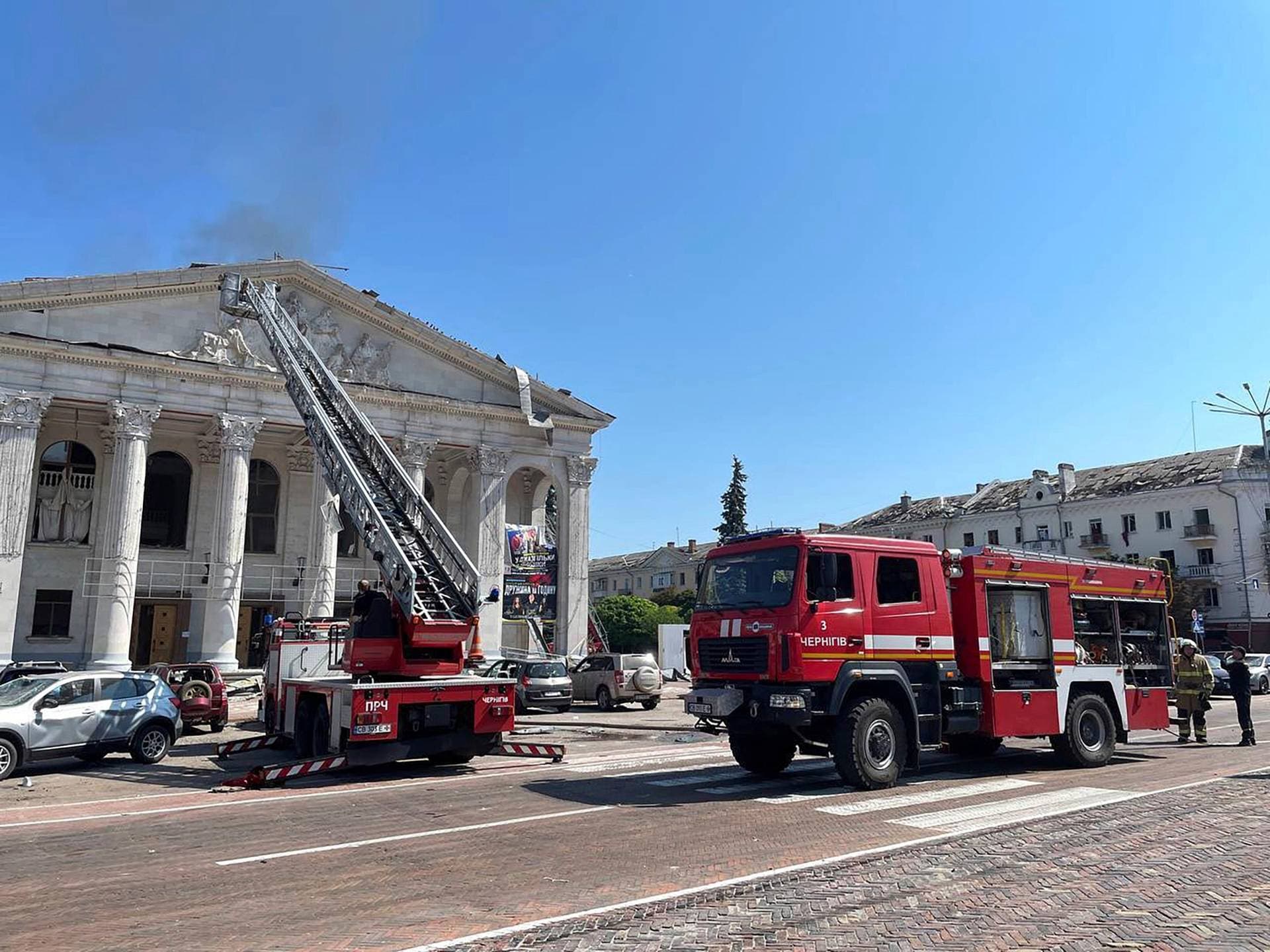 firefighters work at the Chernihiv Drama Theatre damaged by a Russian attack in Chernihiv