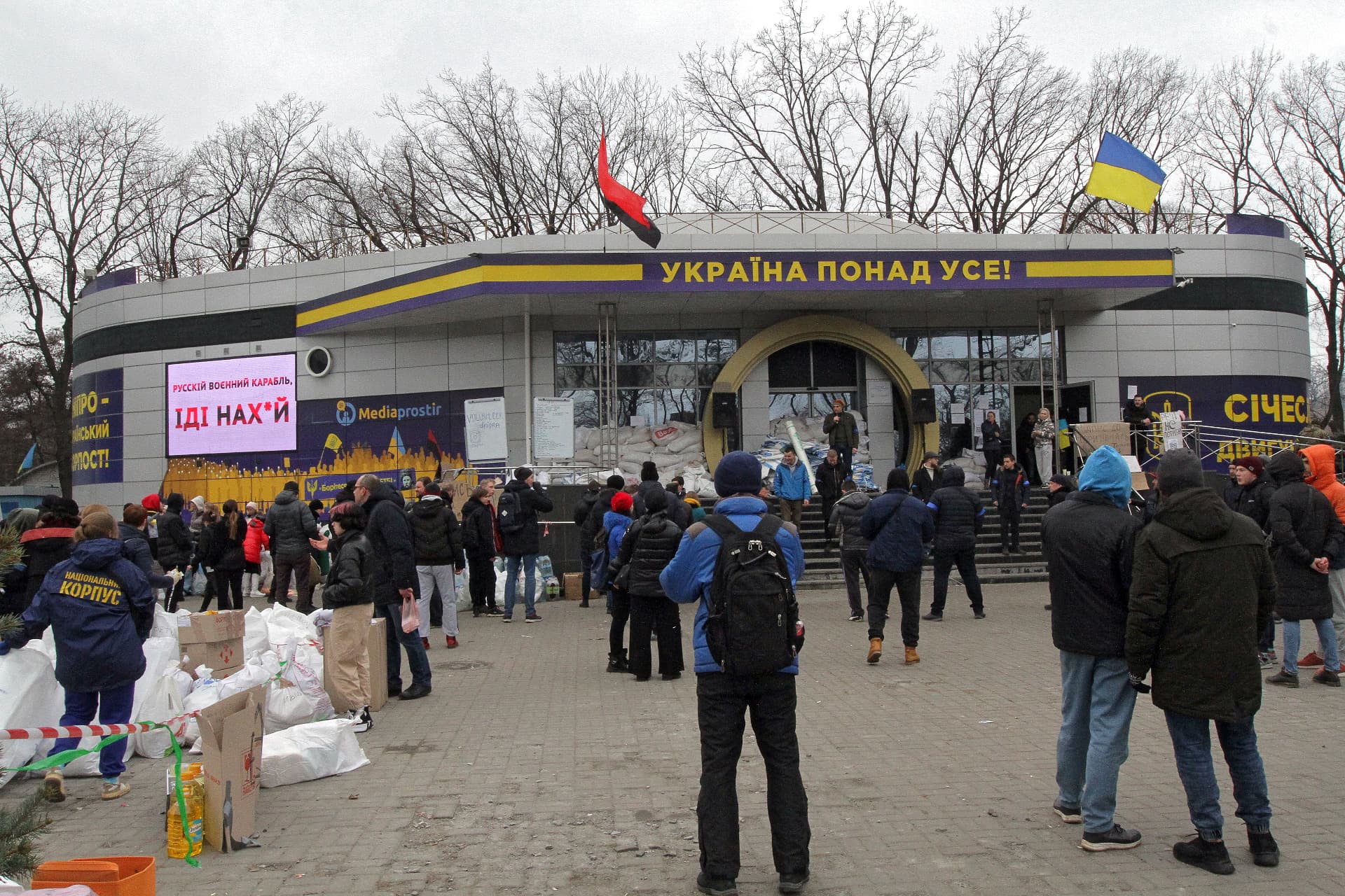 People crowd outside the volunteer and mobilization point set up in the Media Space building near the Dnipropetrovsk Regional State Administration, Dnipro, central Ukraine
