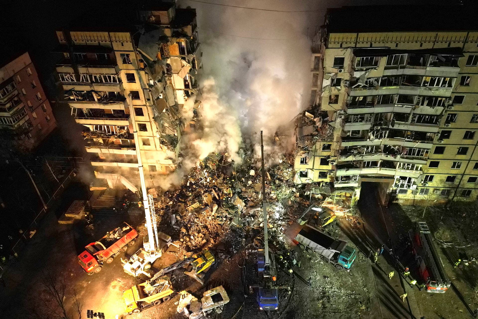 smoke rises after a Russian rocket hit a multistory building leaving many people under debris in Dnipro
