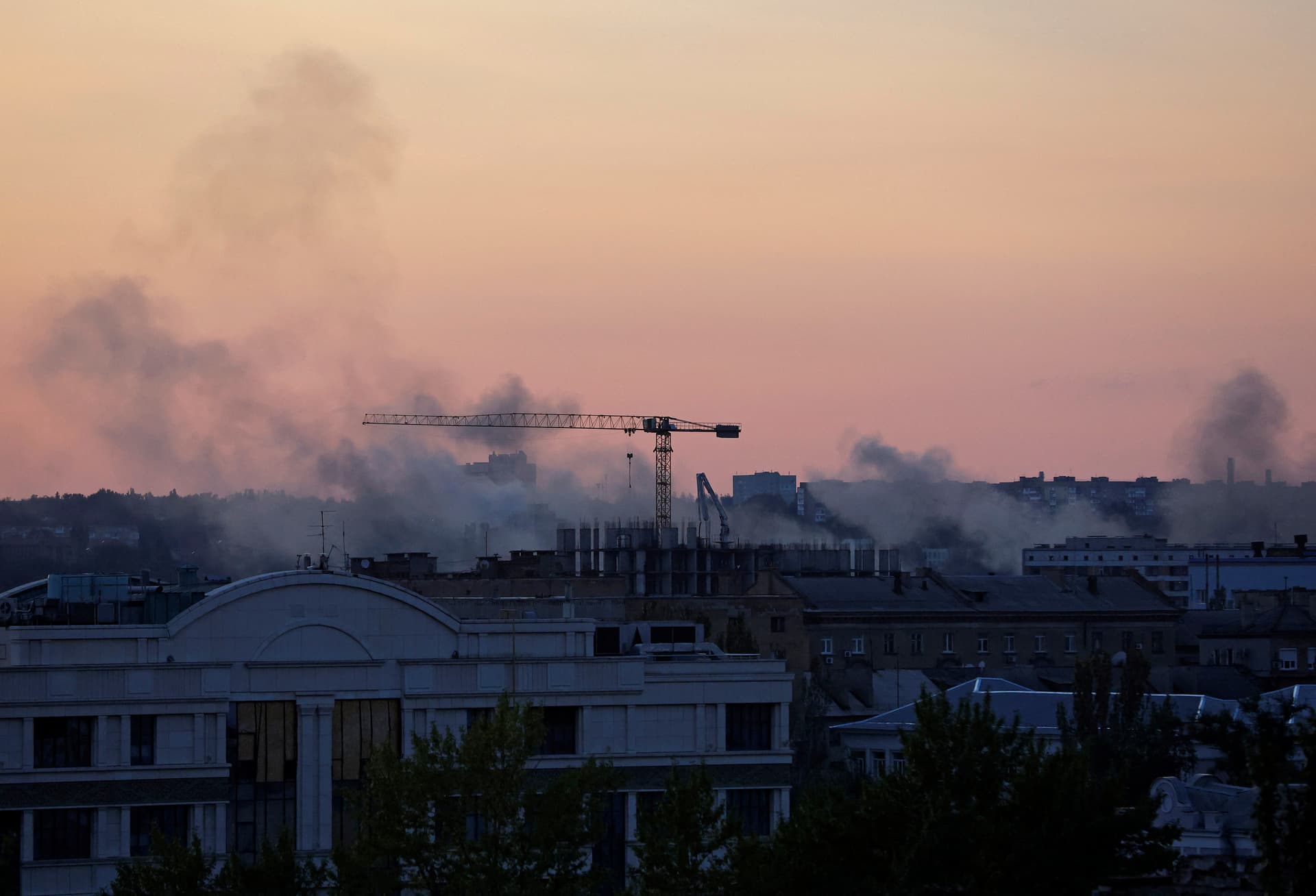 Smoke rises above buildings following a shelling in Donetsk