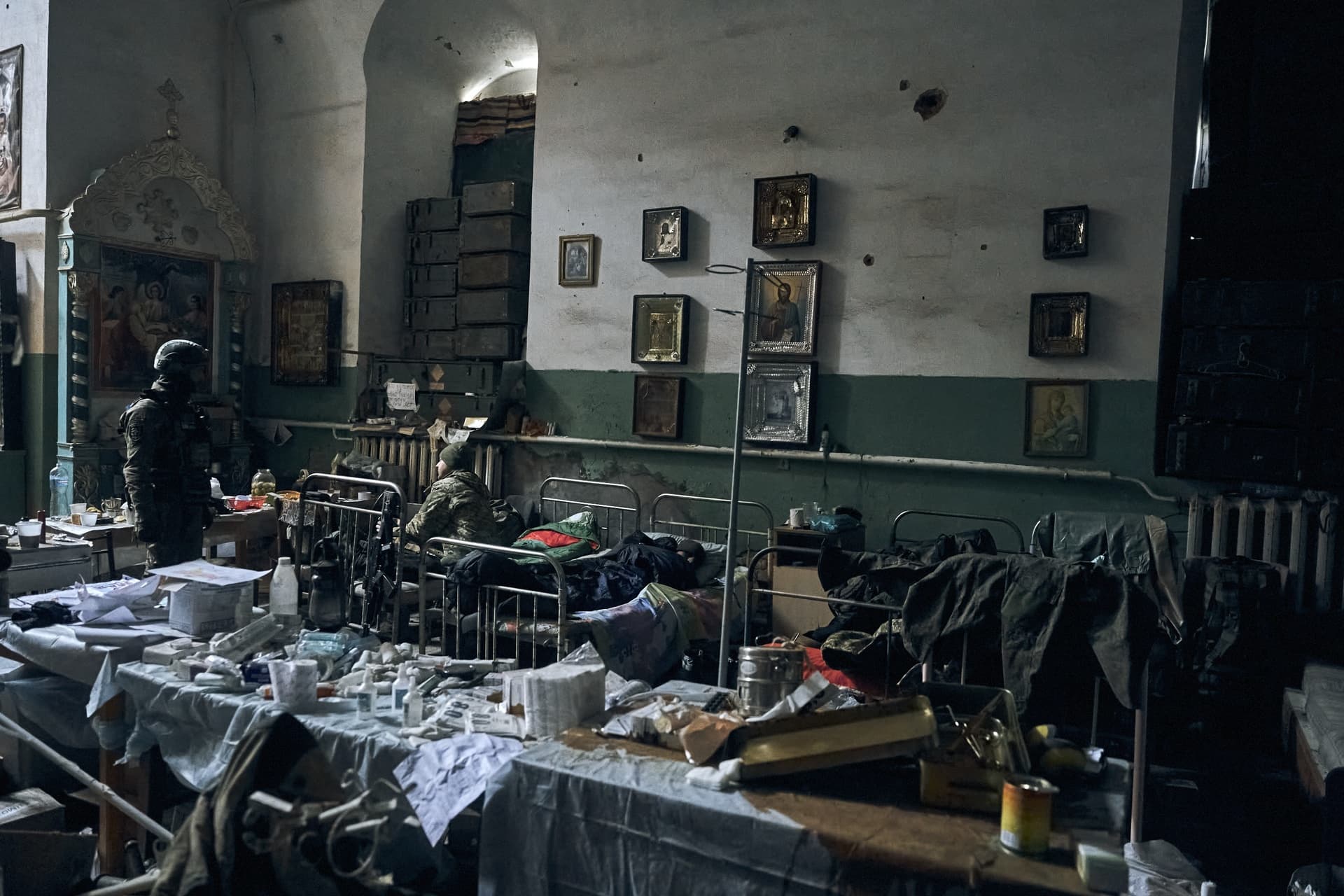 Ukrainian soldiers inspect an improvised Russian military hospital in a church in Izium