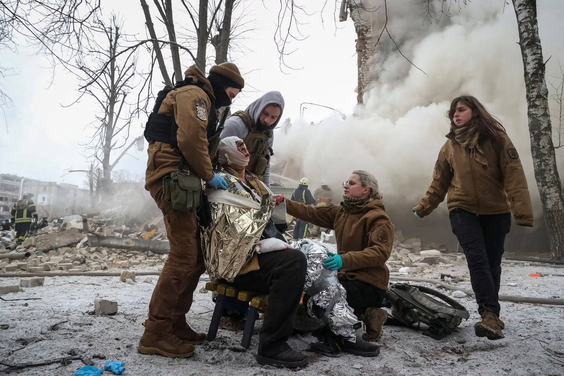 Medical workers treat a wounded resident at a site of residential buildings heavily damaged during a Russian missile attack in Kharkiv