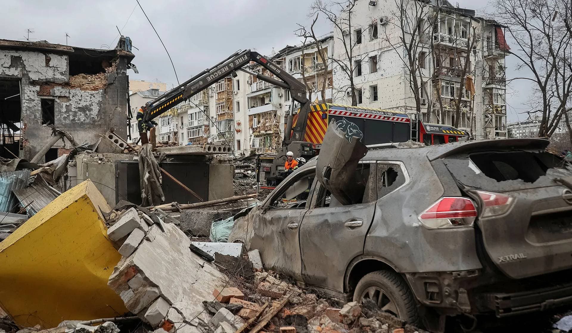 Rubble and a damaged car at the site where a residential building was heavily damaged during a Russian missile attack in central Kharkiv