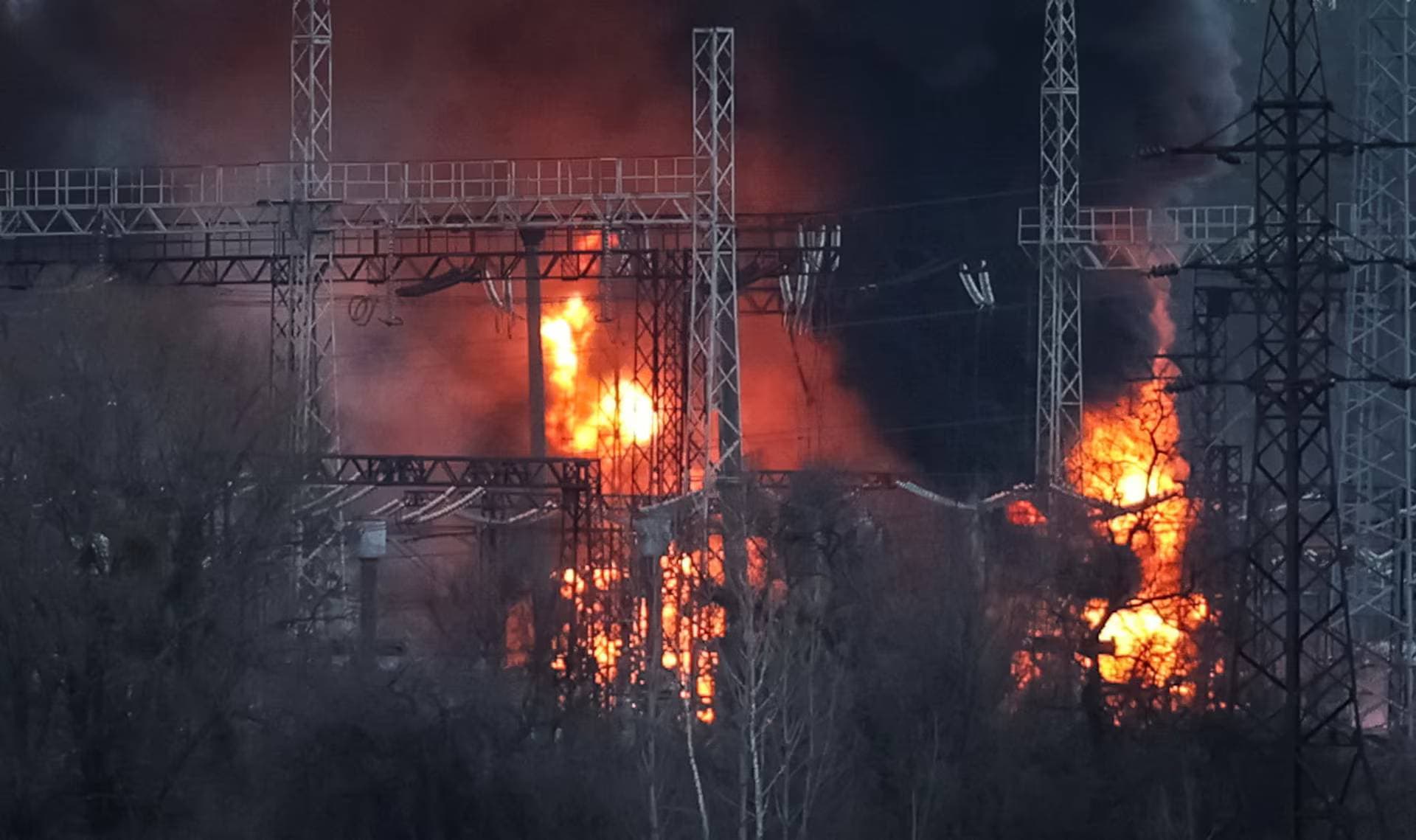 Smoke and fire seen around high-voltage lines at a site of a Russian missile strike outside Kharkiv