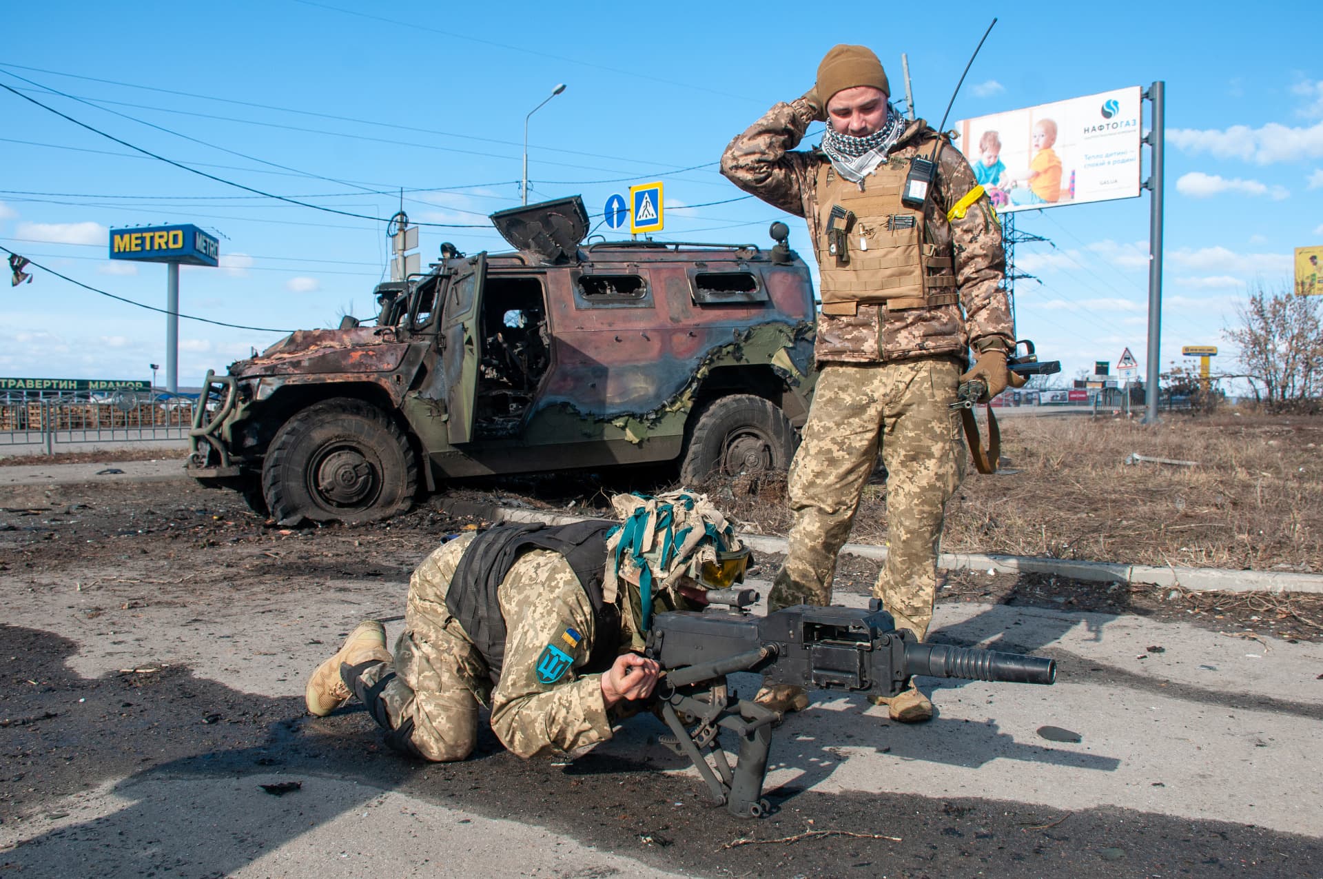 Soldiers near the burnt Russian AFV Tiger in Kharkiv