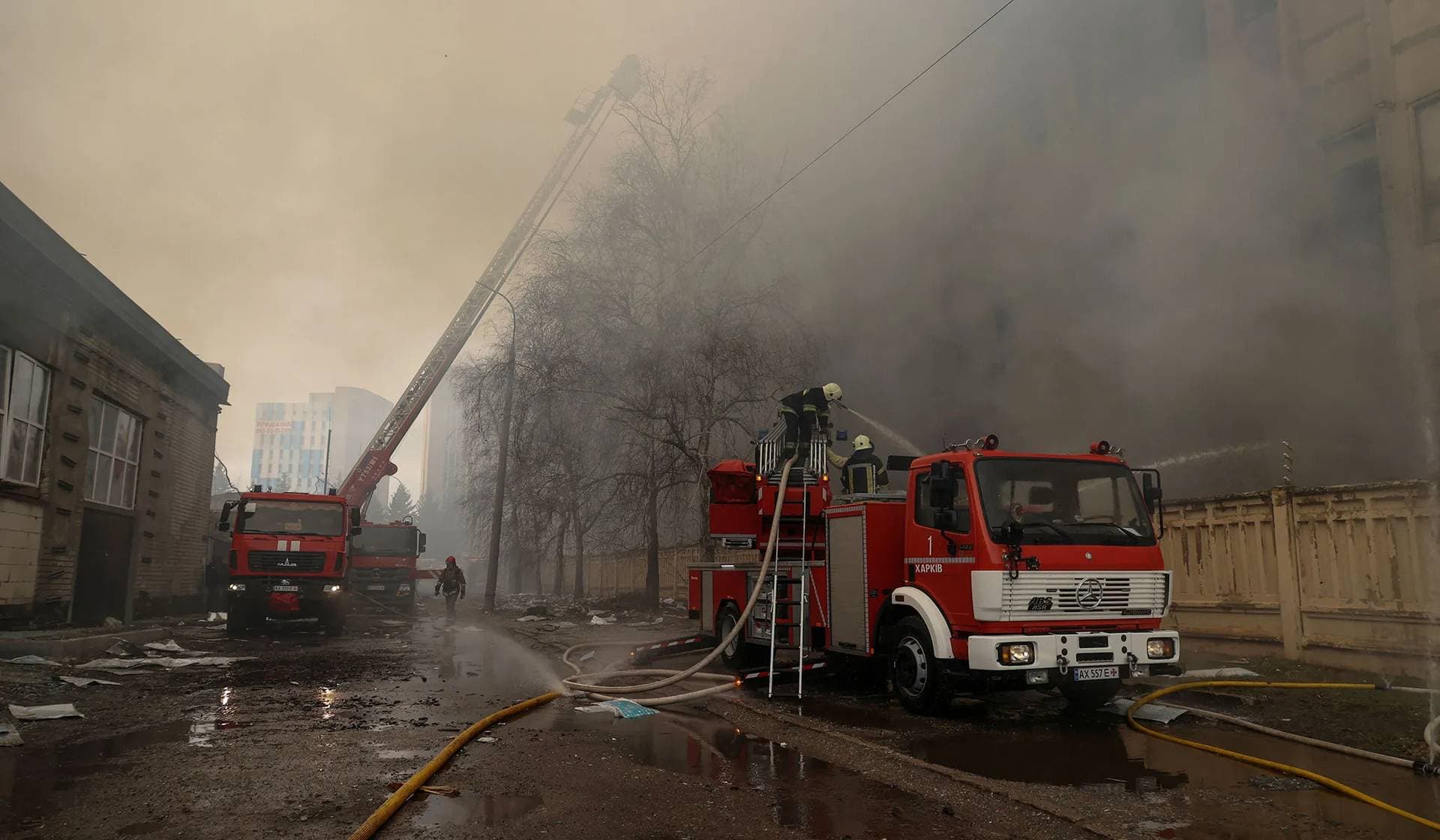 Firefighters work at a site of a printing house hit by a Russian missile strike in Kharkiv