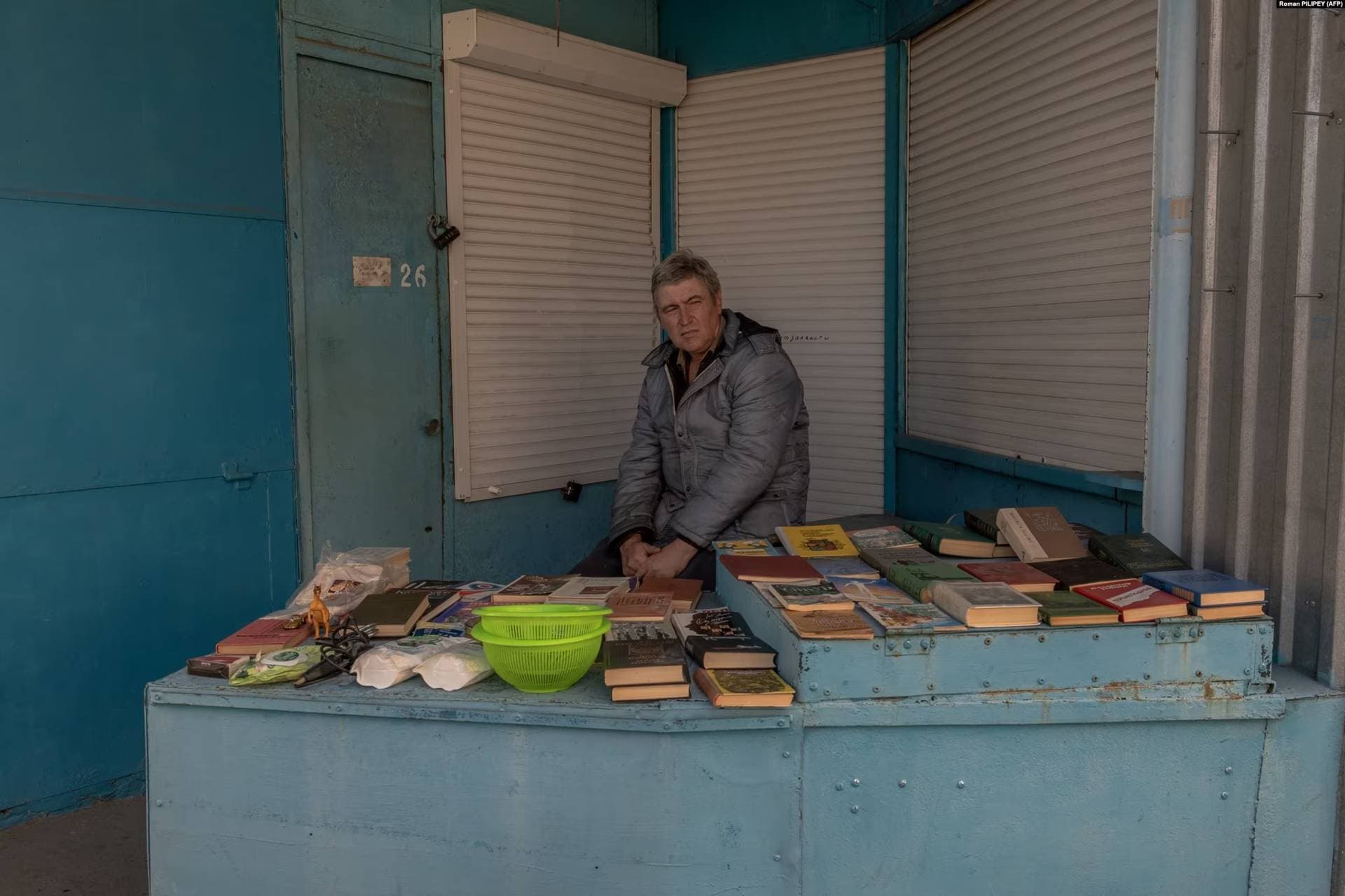 A man sells books at a market in Kherson