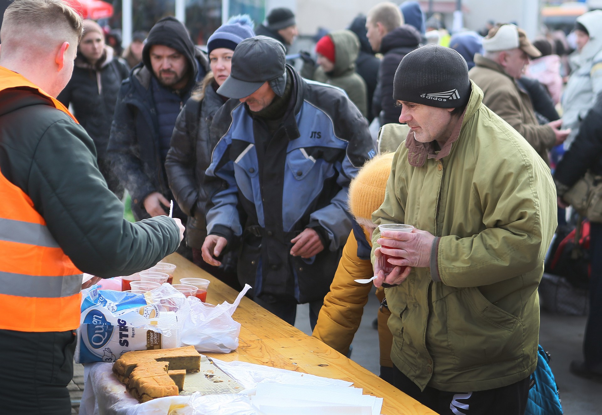 Volunteers distribute hot meals to refugees at a refugee center in Lviv