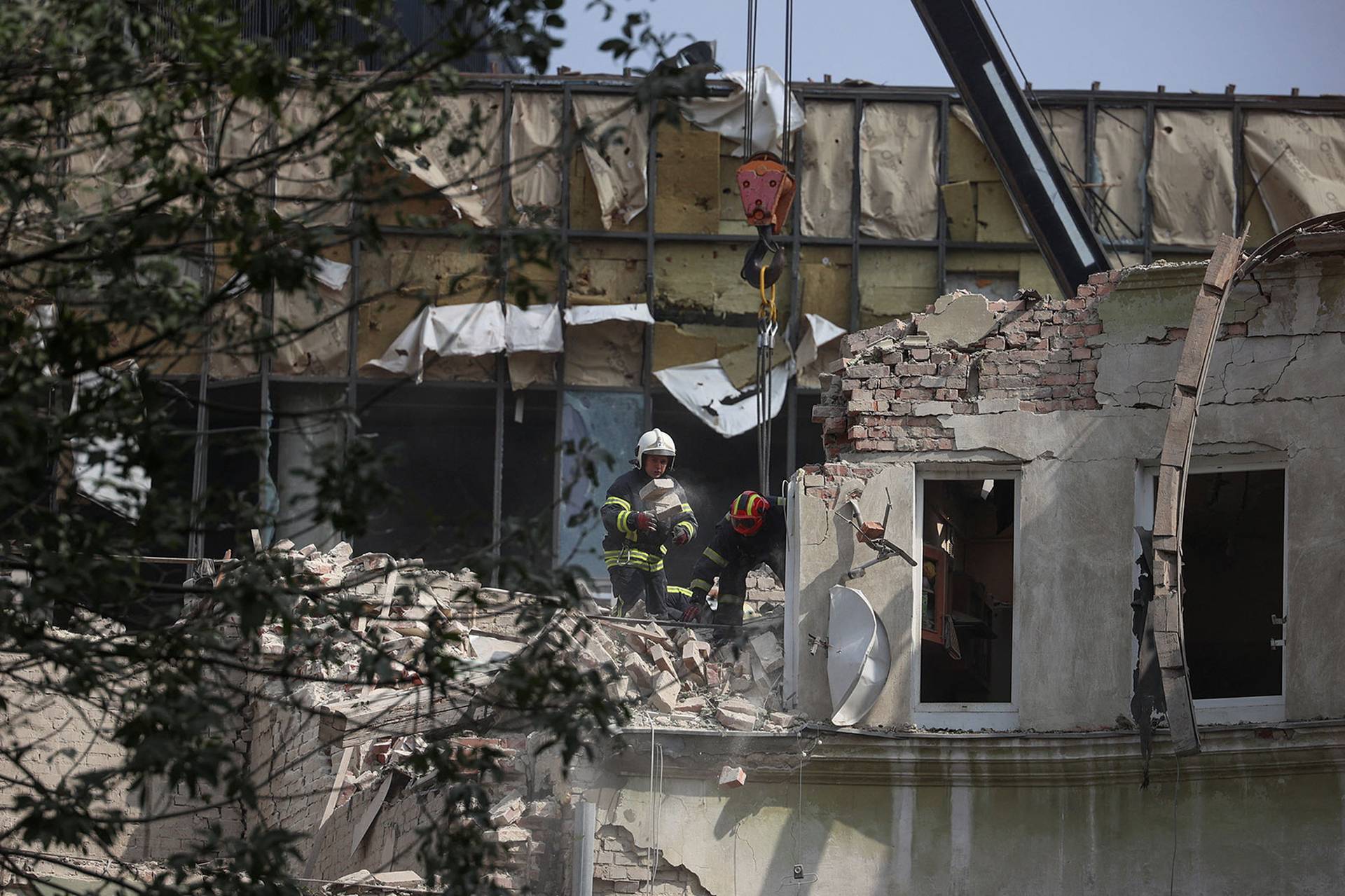 Rescuers work at a site of a residential building hit by a Russian missile strike in Lviv
