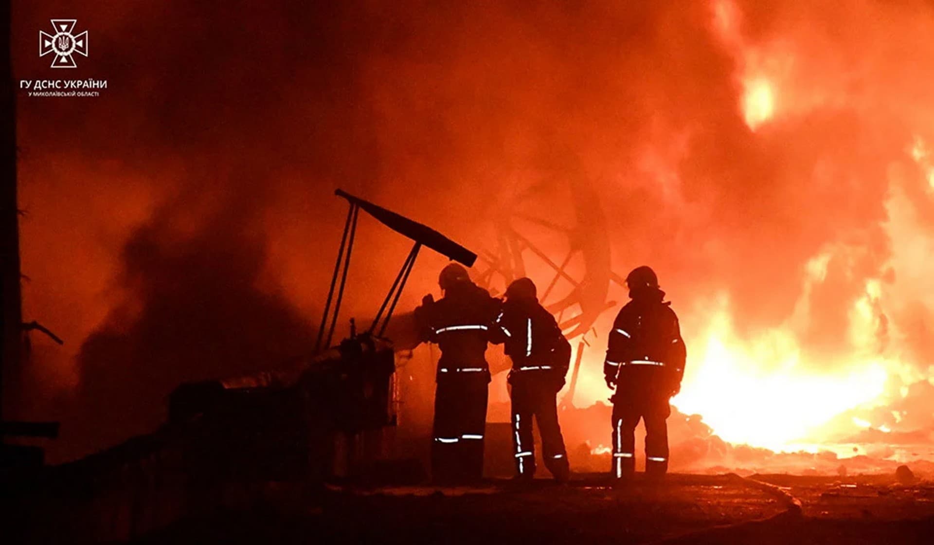 Firefighters work at a site of a sunflower oil storage tanks fire after strikes by Russian suicide drones in Mykolaiv