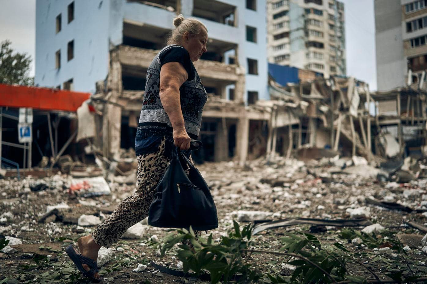 A woman passes by destroyed buildings after the Russian shelling in Mykolaiv