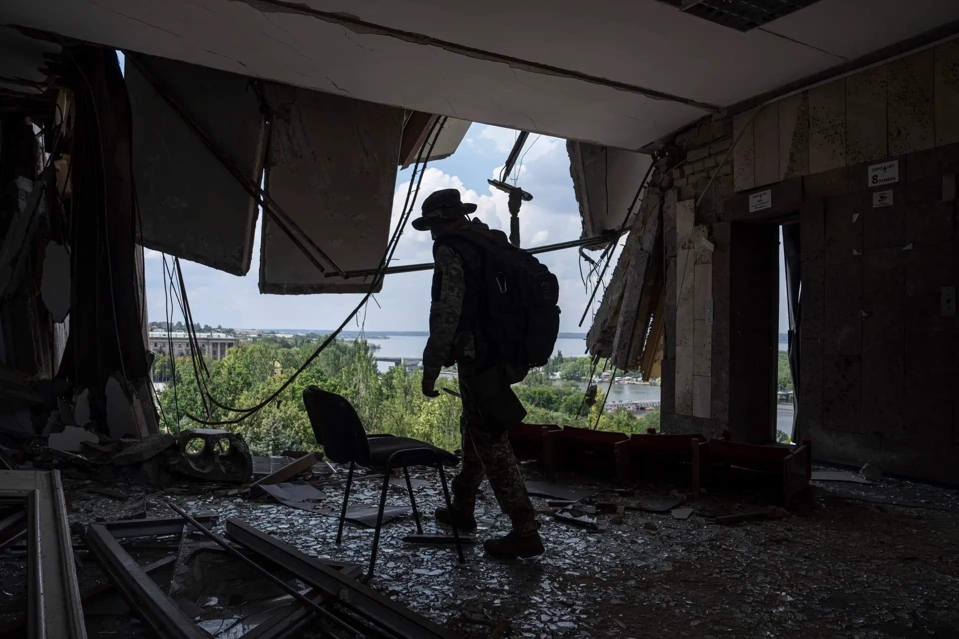 A Ukrainian serviceman walks inside of the headquarters of the Mykolaiv Regional Military Administration building destroyed by a Russian attack in Mykolaiv