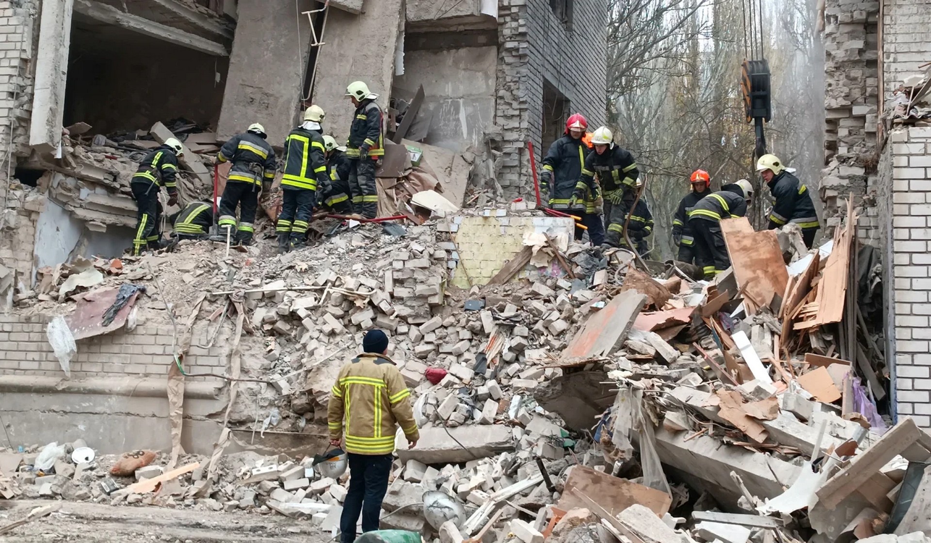 Rescuers work at a site of a residential building heavily damaged by a Russian missile attack in Mykolaiv