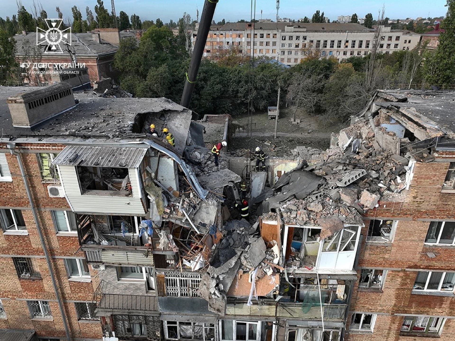 Rescuers work at the site of an apartment building damaged by a Russian military strike in Mykolaiv