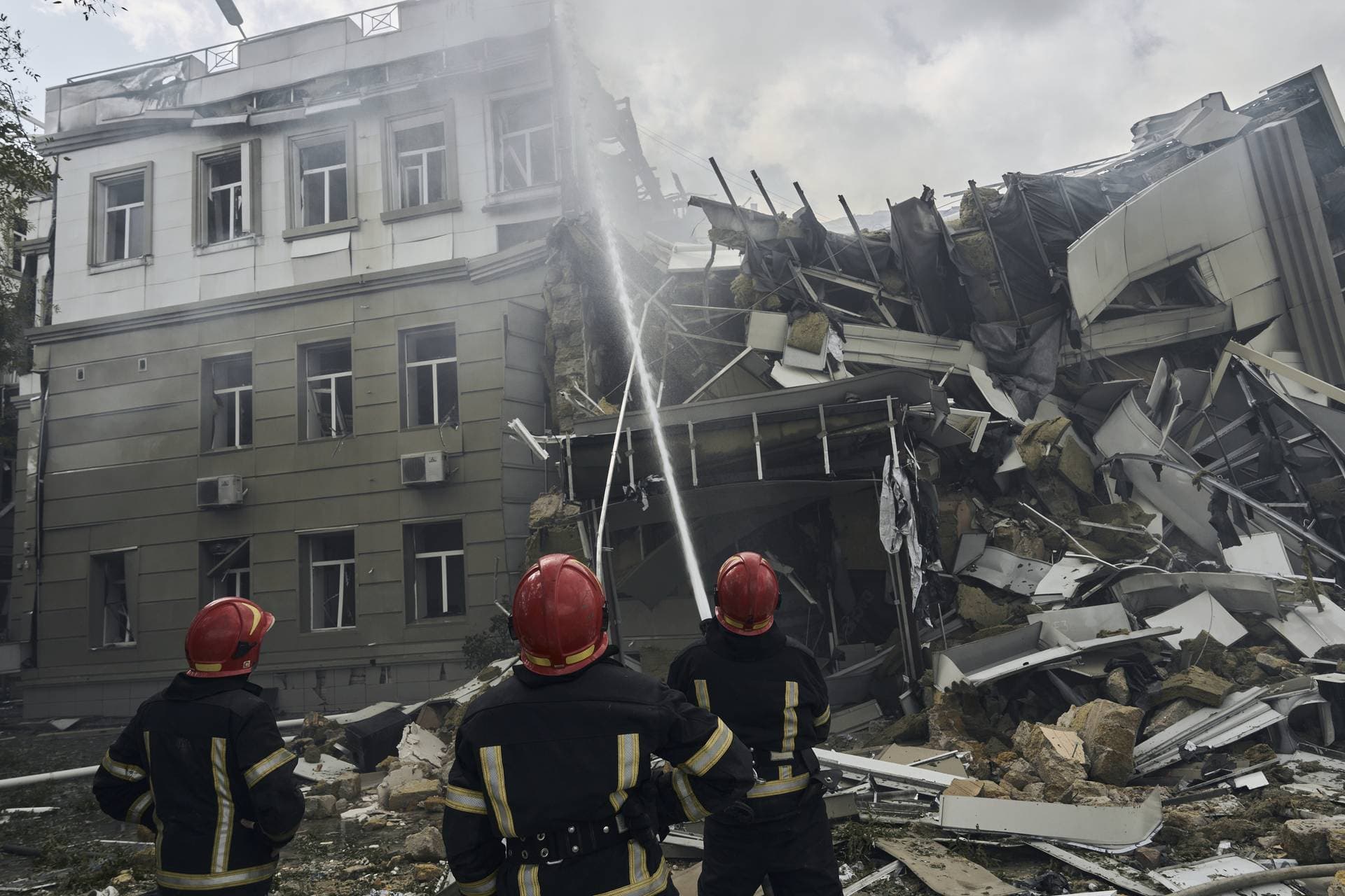 Emergency service personnel work at the site of a destroyed building after a Russian attack in Odesa