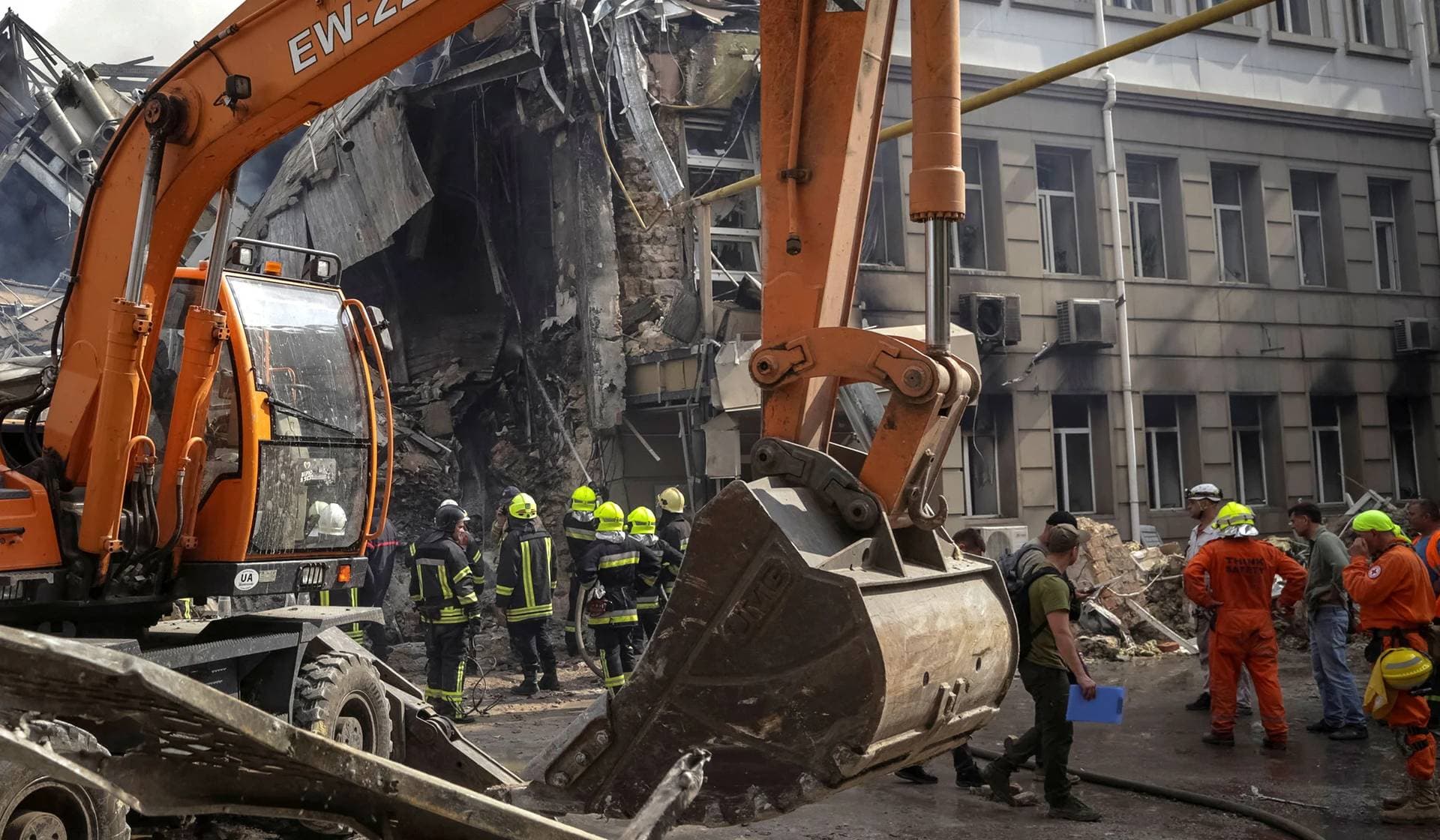 Rescuers work at a site of a building heavily damaged by a Russian missile attack in central Odesa