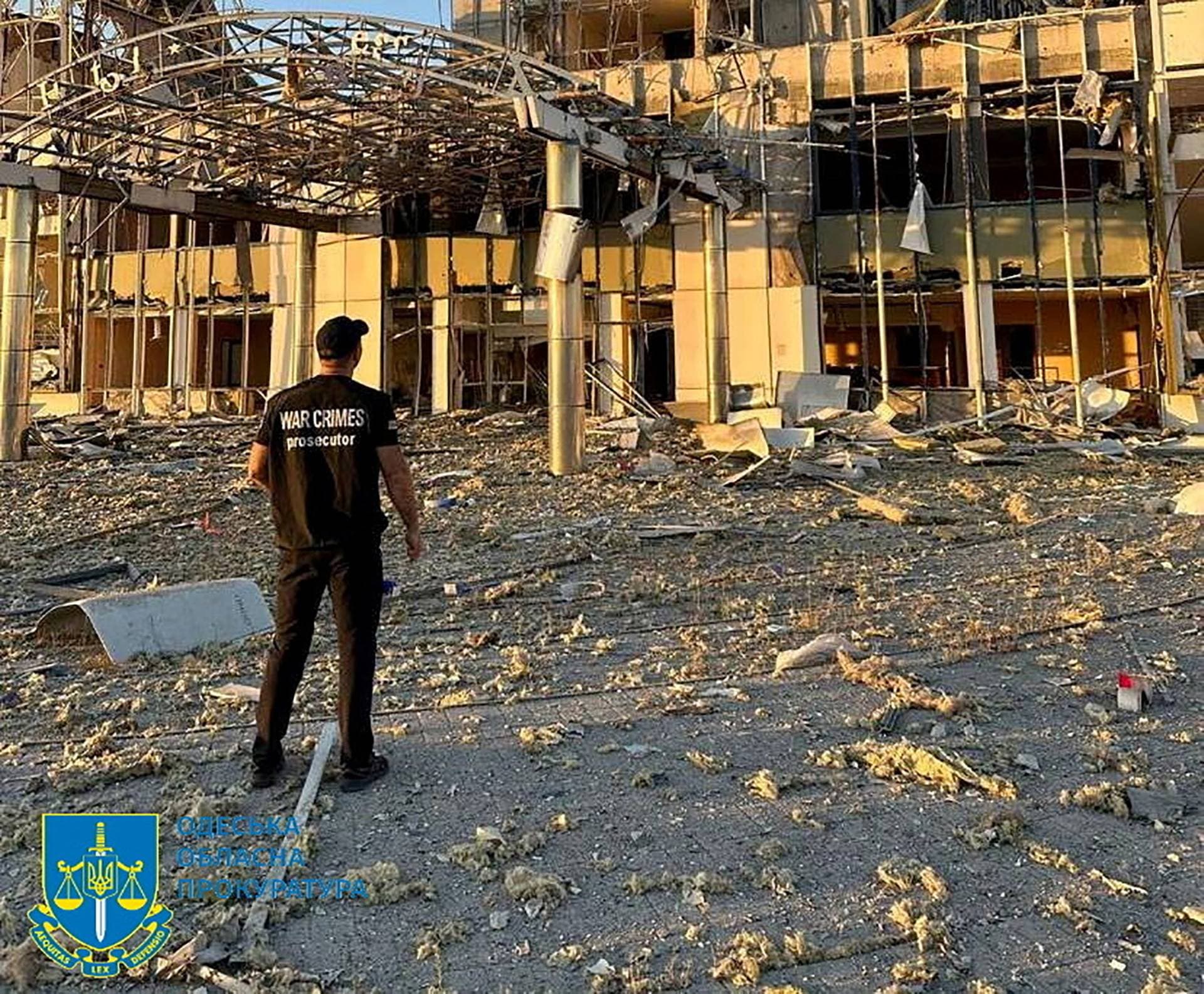 A member of Odesa Regional Prosecutor's Office personnel inspects damage following a Russian military attack in Odesa