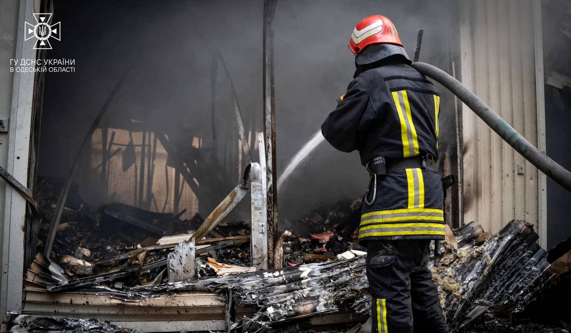 A firefighter works at a site of storage facilities hit during Russian missile and drone strikes in Odesa