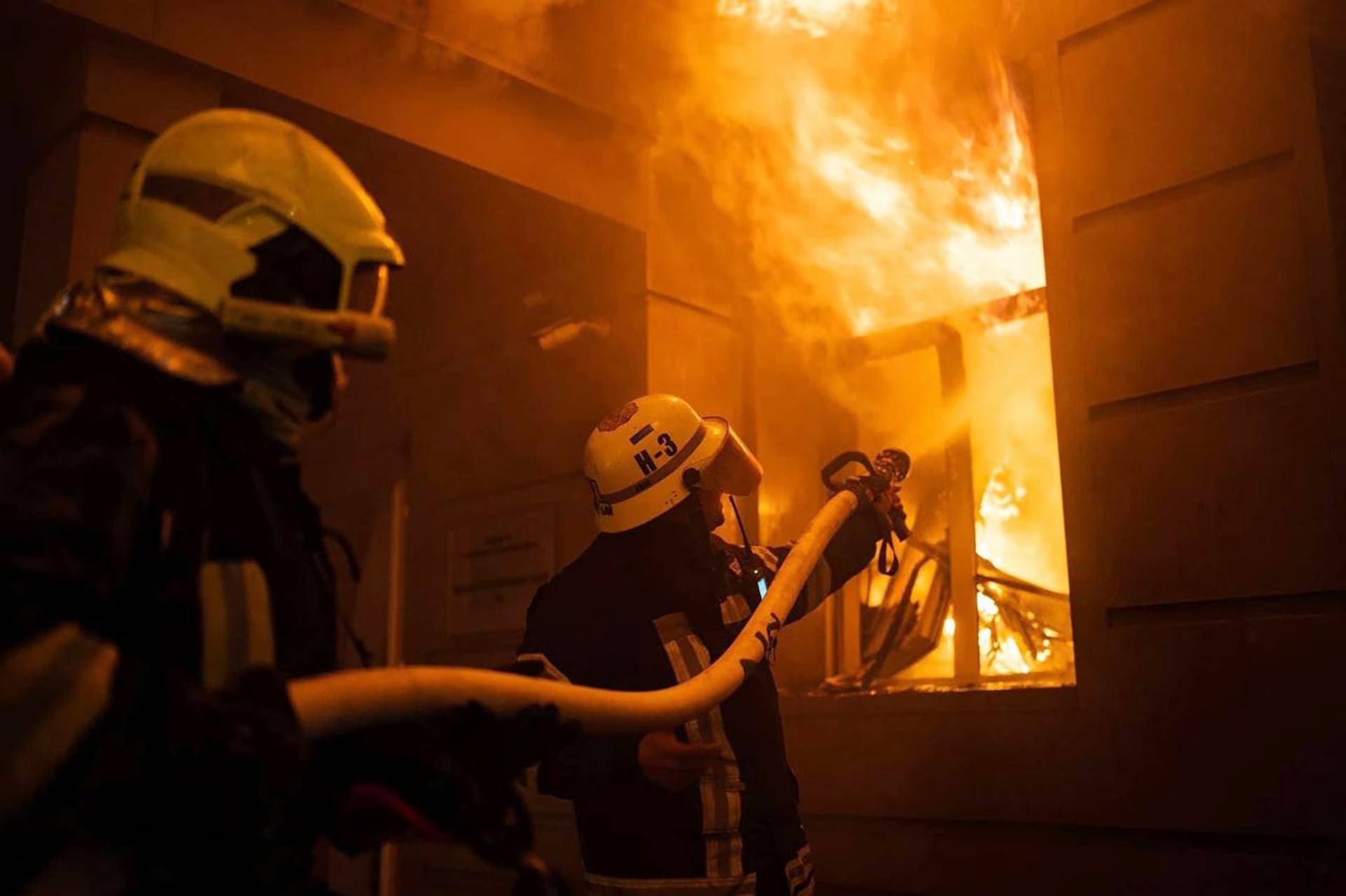 firefighters work to extinguish a fire after a Russian attack in Odesa