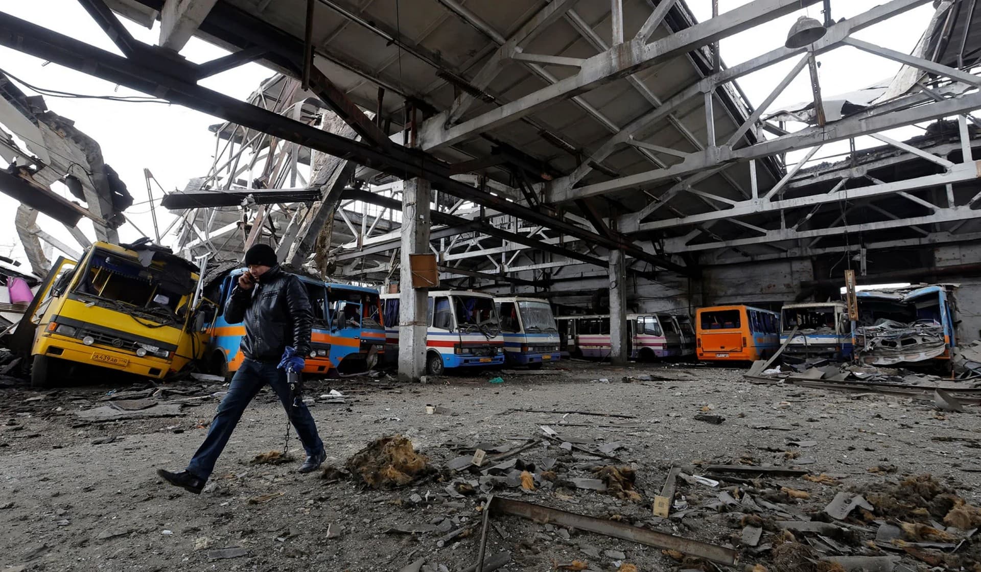 A man walks through the bus depot damaged by recent shelling in Volnovakha