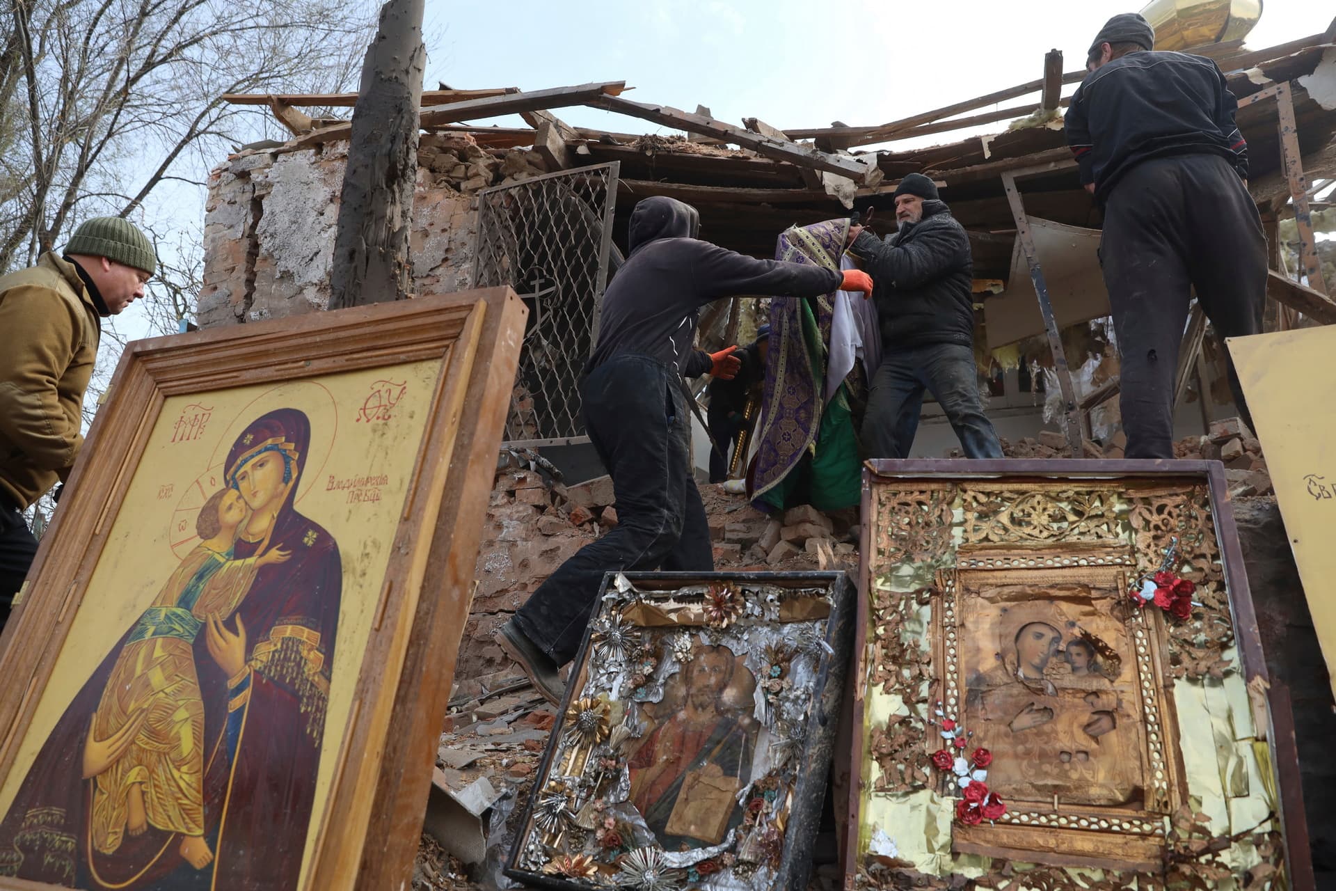 People save icons as they clear the rubble after a Russian rocket ruined an Orthodox church in rocket attack on Easter night in Komyshuvakha