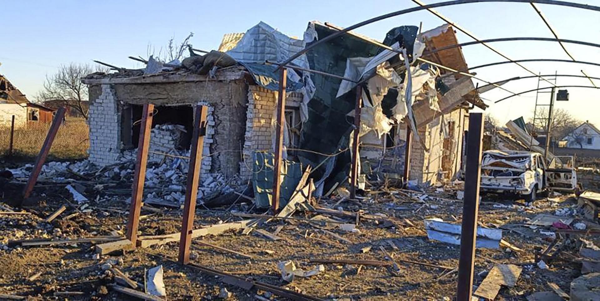a damaged building and a car are seen after a Russian strike in the village of Novosofiivka