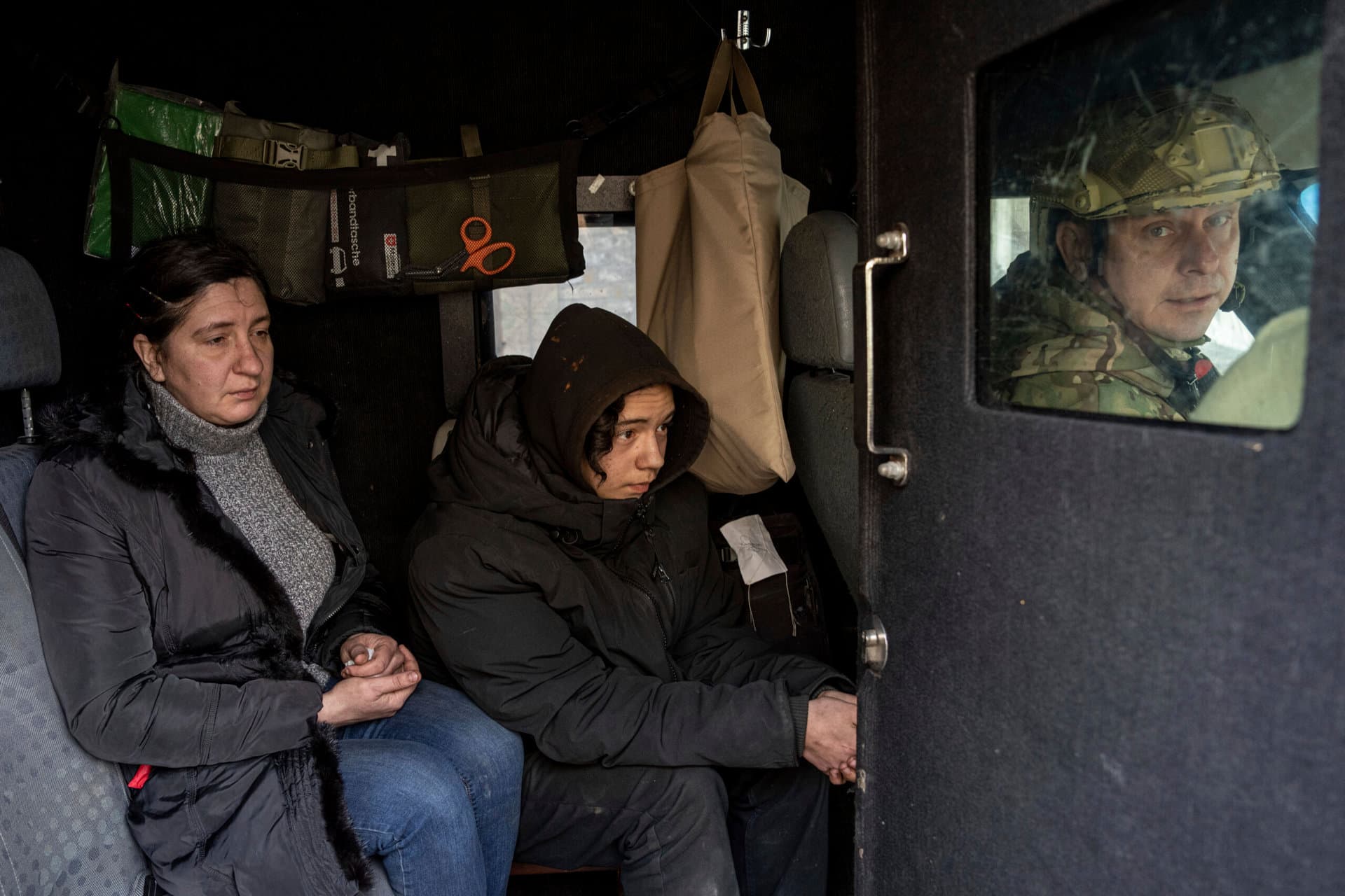 Svitlana Mazurina and her son Oleksii ride in a van during an evacuation by Ukrainian police in Avdiivka
