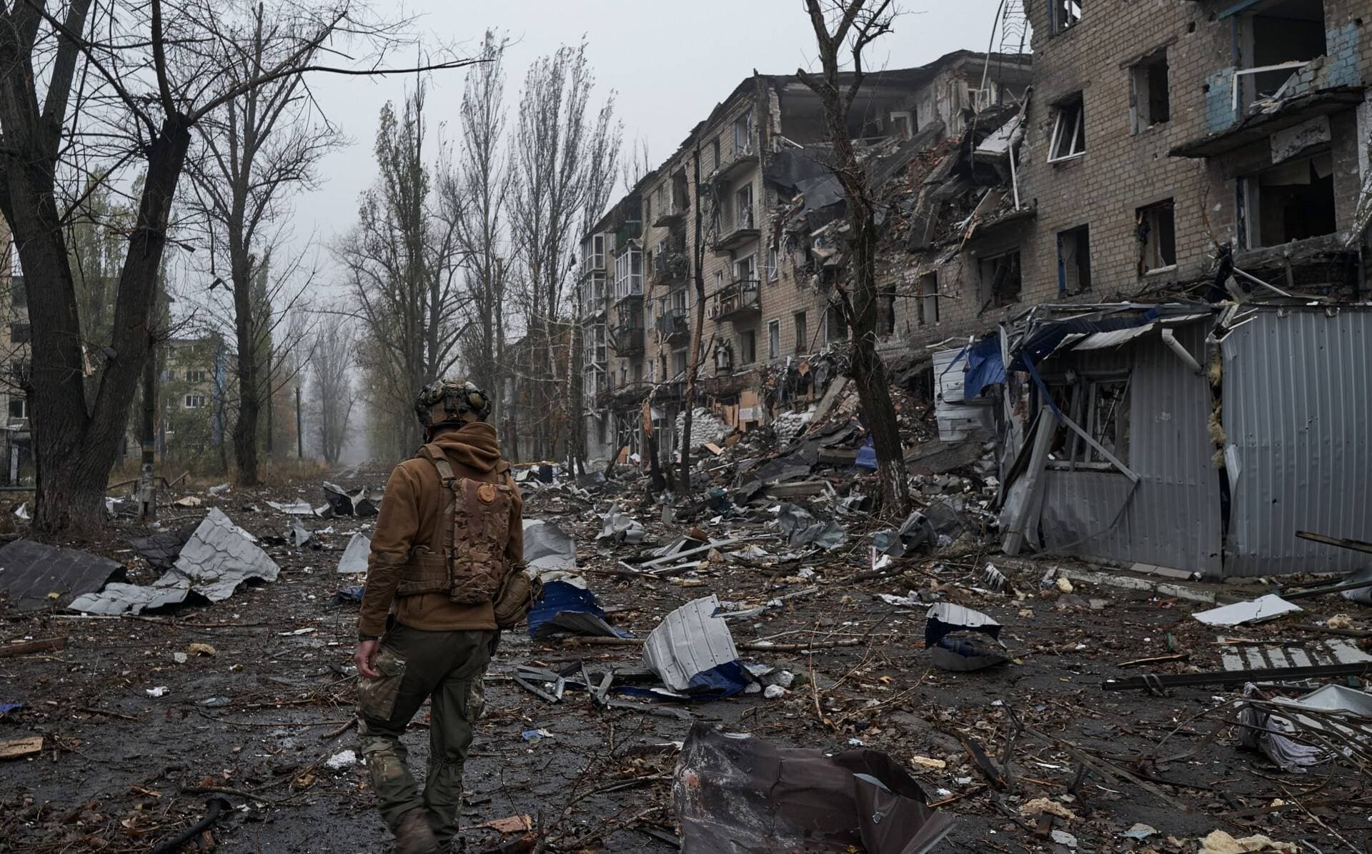 A Ukrainian soldier walks through the destroyed streets of Avdiivka