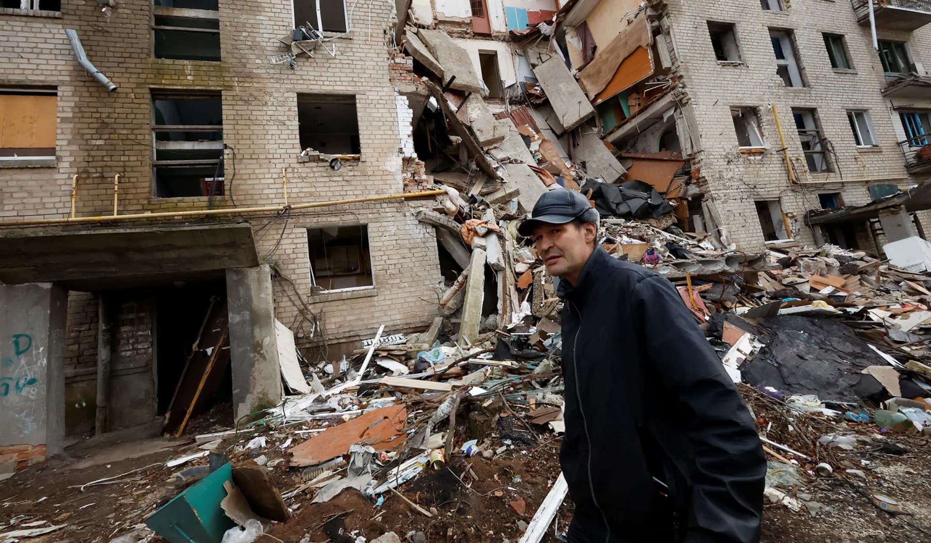 A man walks past an apartment block destroyed by a missile strike in the frontline Donbas city of Bakhmut