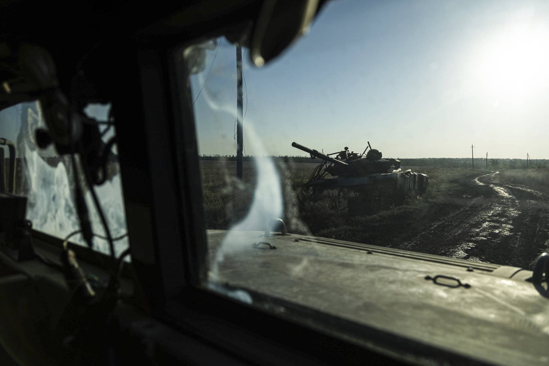 A destroyed tank is seen from the window of an armored vehicle near Klishchiyivka