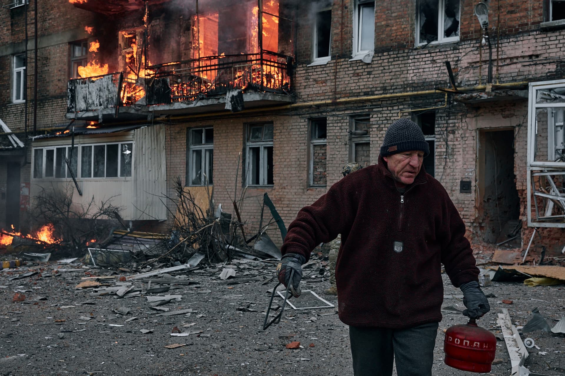 A local resident leaves his home after Russian shelling destroyed an apartment house in Bakhmut
