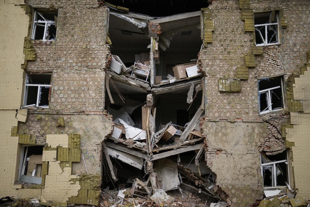 Debris hangs from a residential building heavily damaged in a Russian bombing in Bakhmut