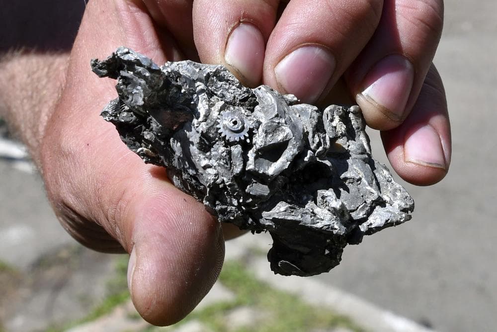 A man shows a part of a missile found in a residential area after Russian shelling in Bakhmut