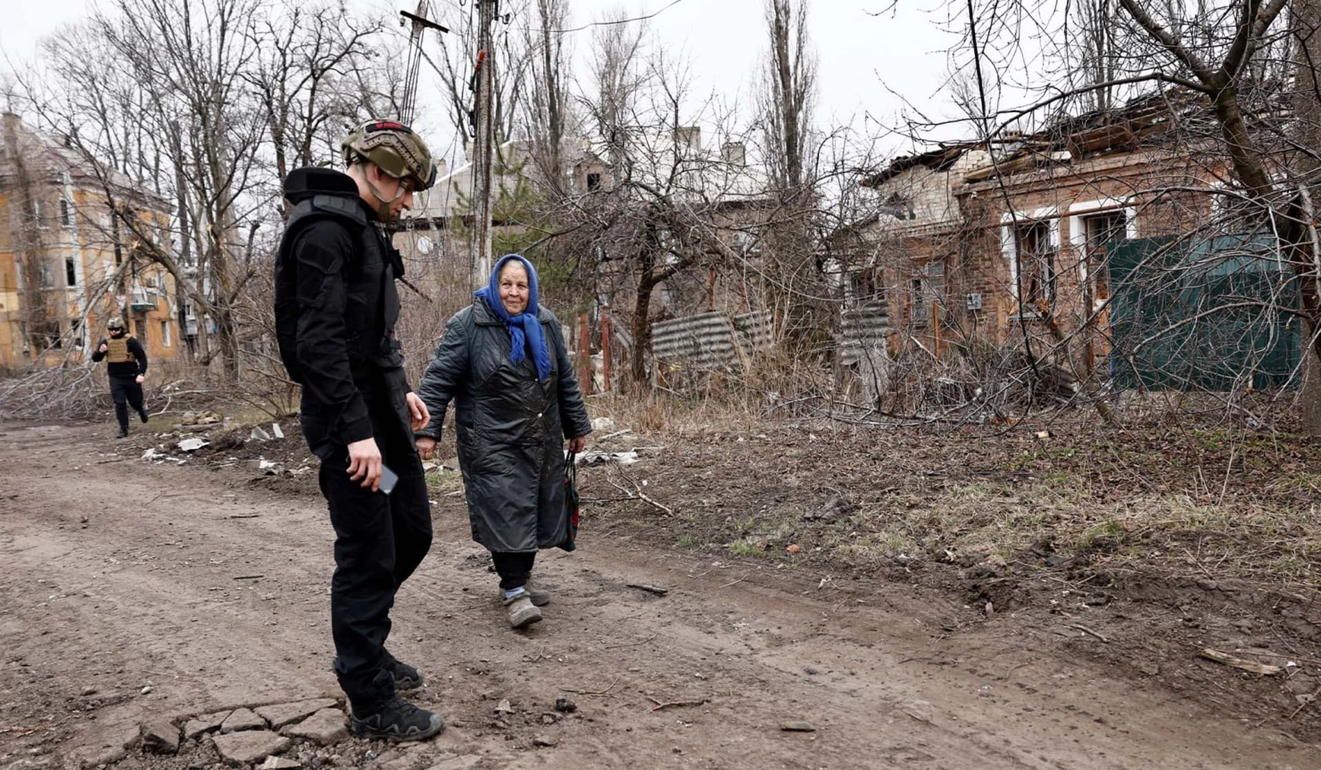 A Ukrainian volunteer tries to convince a resident to evacuate near the frontline in Chasiv Yar
