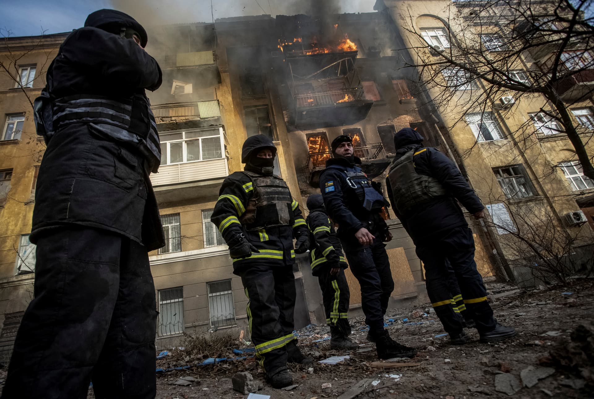 Emergency workers put out the fire after Russian shelling hit an apartment building in Bakhmut