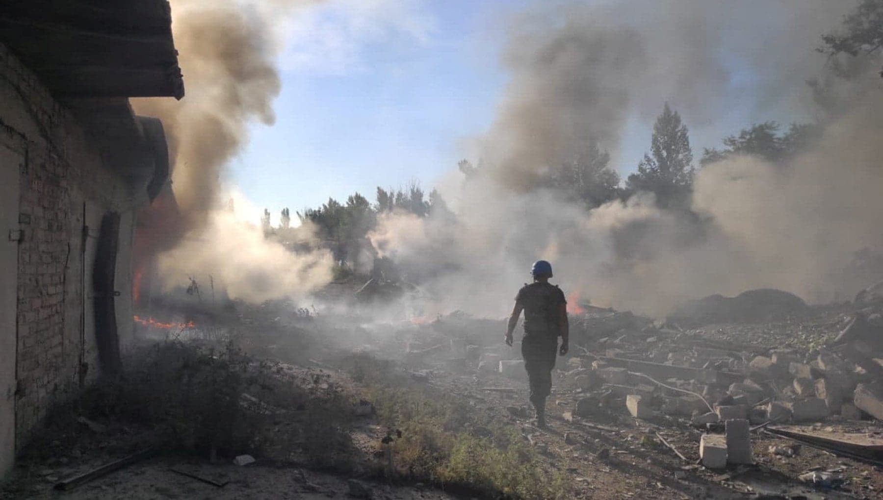 A rescue worker walks among debris at a residential area destroyed by a Russian military strike in the town of Toretsk