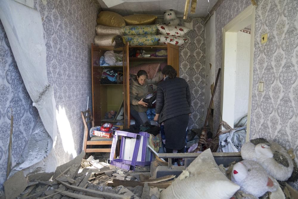Women collect belongings in their apartment destroyed by Russian airstrike in Bakhmut