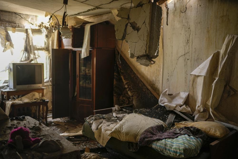 Debris spread in a living room of an apartment of residential building heavily damaged in a Russian bombing in Bakhmut