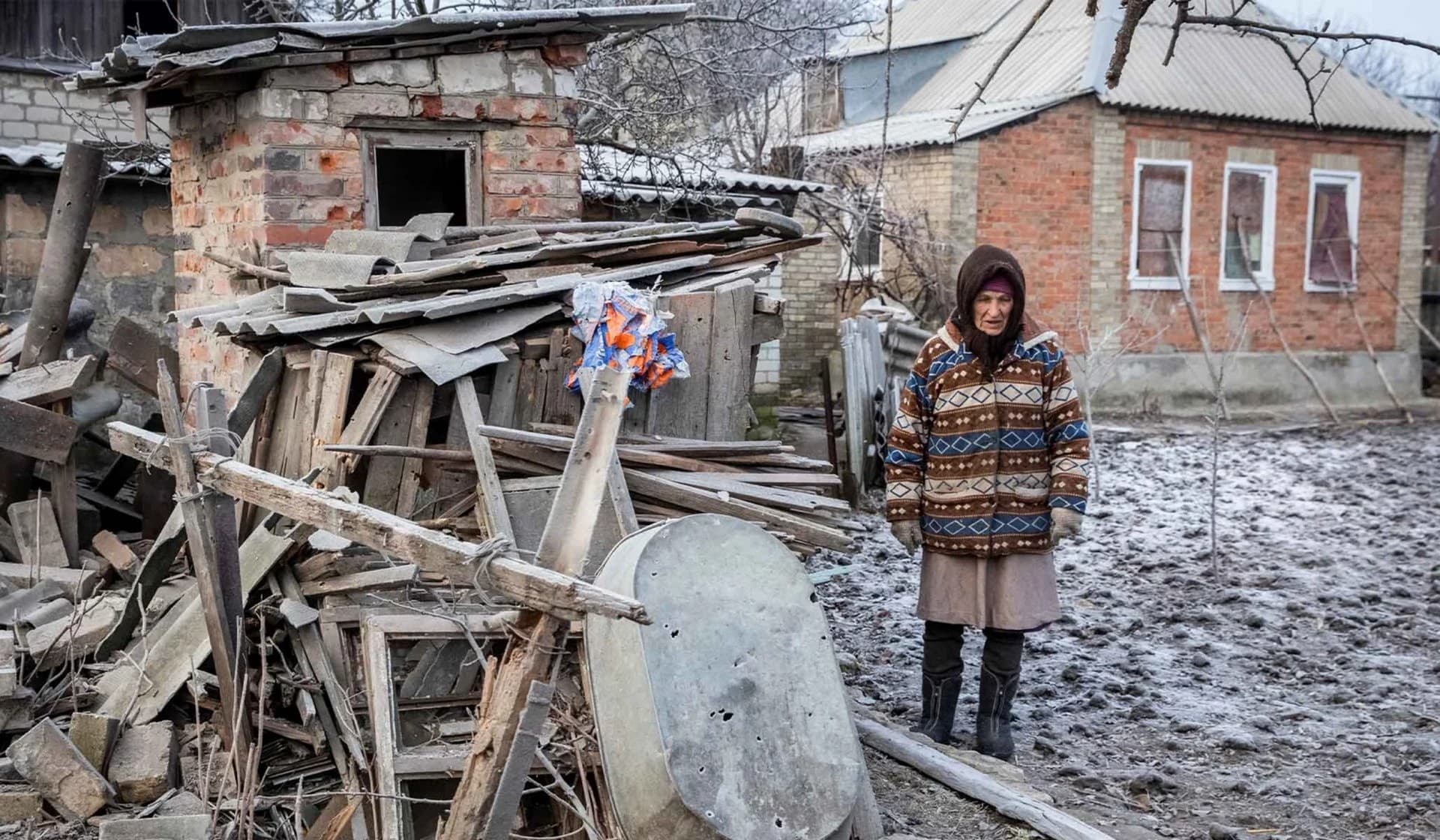 A local resident stands next to her house damaged by a Russian military strike in Chasiv Yar