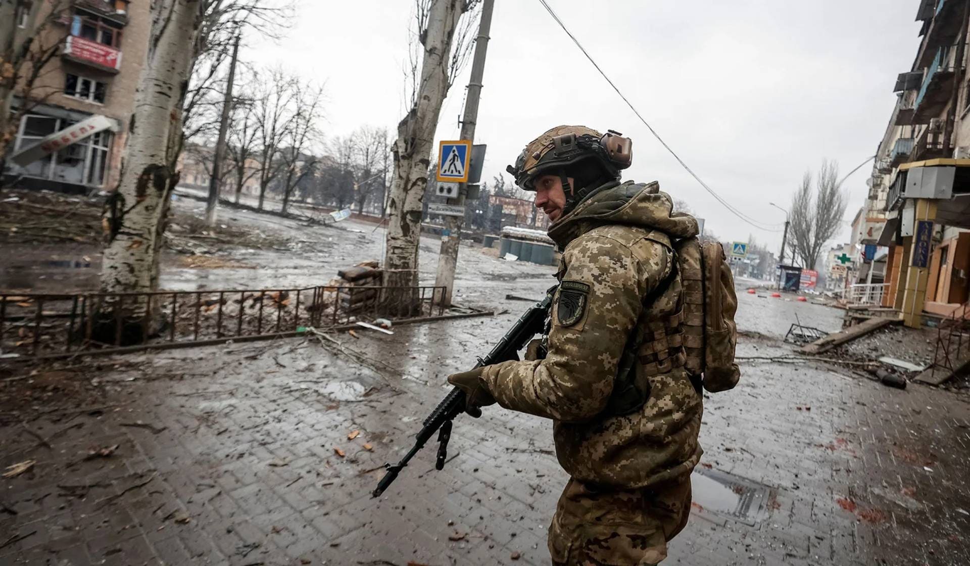 Ukrainian service members on an empty street in the frontline city of Bakhmut