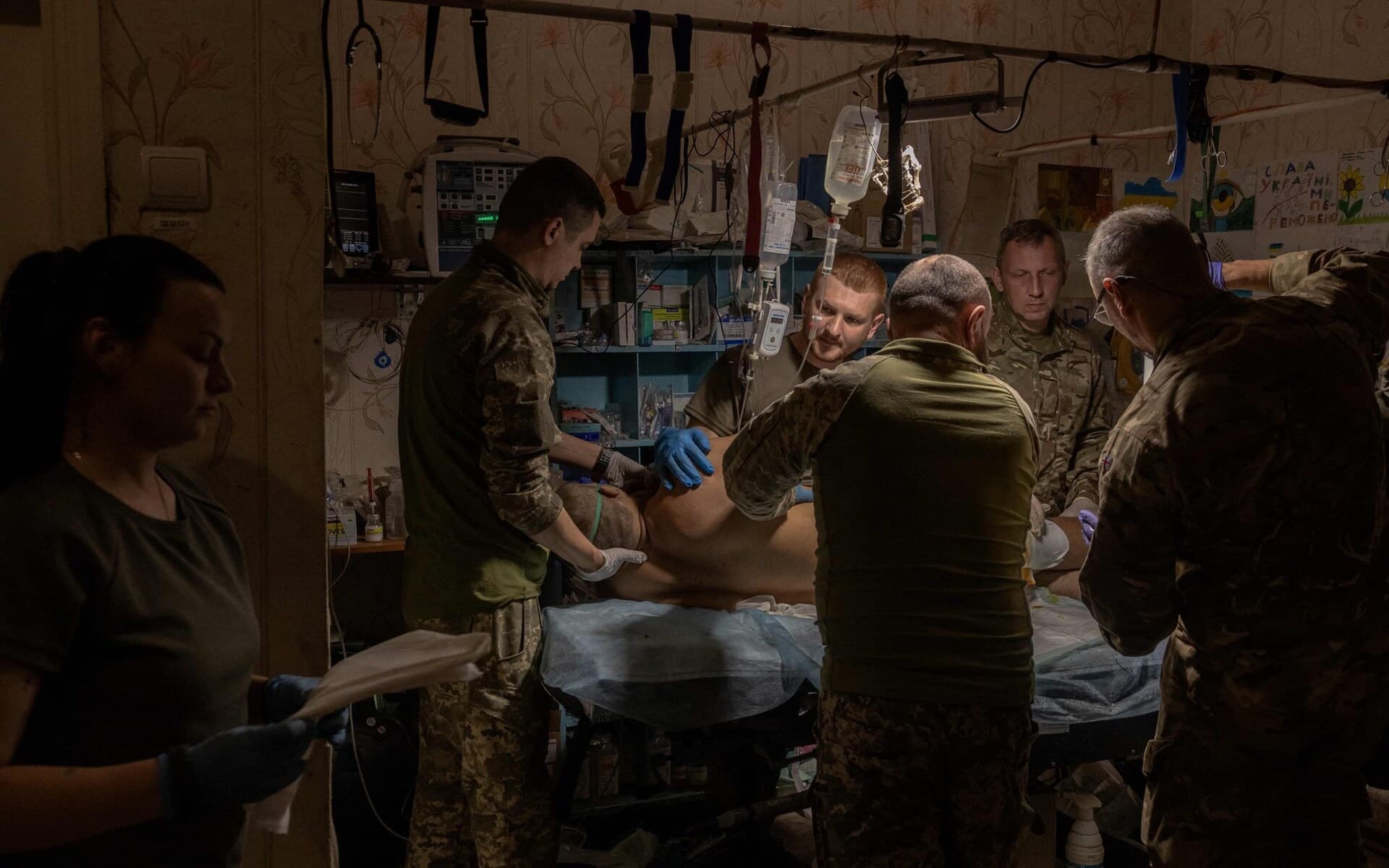 A wounded Ukrainian soldier is treated by Ukrainian military medics in a stabilization point in an undisclosed location near Bakhmut