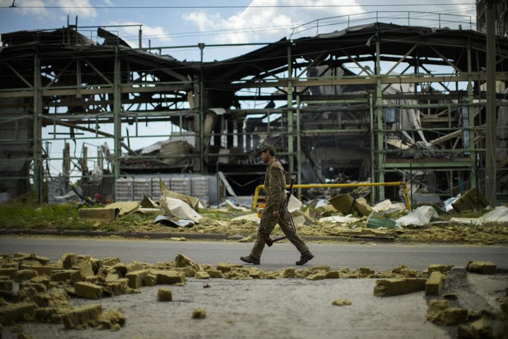 A Ukrainian serviceman walks past a gypsum manufacturing plant destroyed in a Russian bombing in Bakhmut
