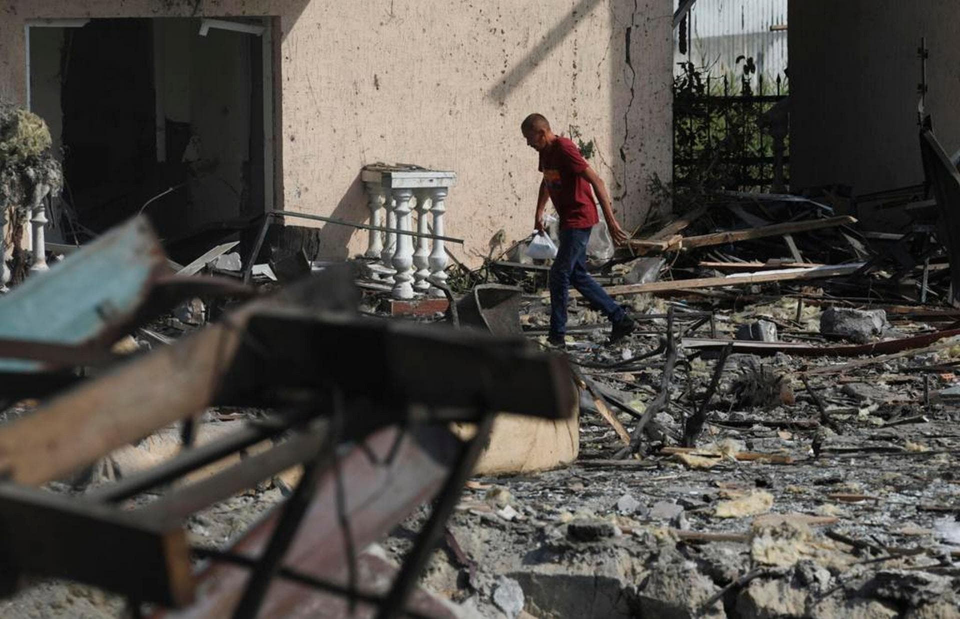 A man passes by buildings of local resort destroyed following recent Russian missile attacks in Odesa region, Ukraine