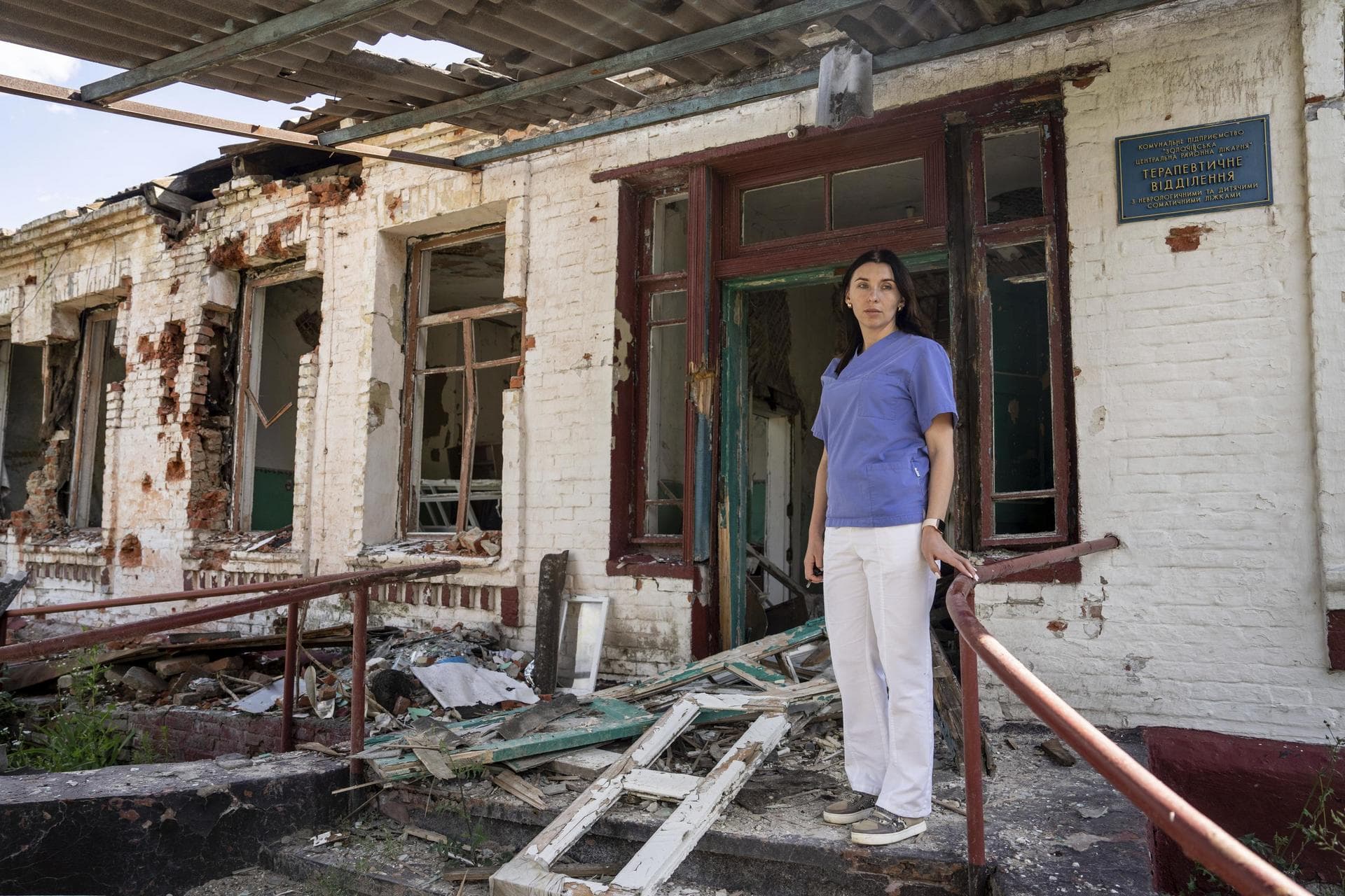 Dr. Ilona Butova stands in front of the therapy department which was destroyed after a Russia attack on the hospital in Zolochiv, Kharkiv region