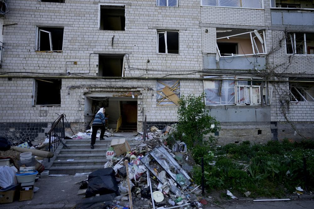 A residents enters her home building ruined by shelling in Borodyanka