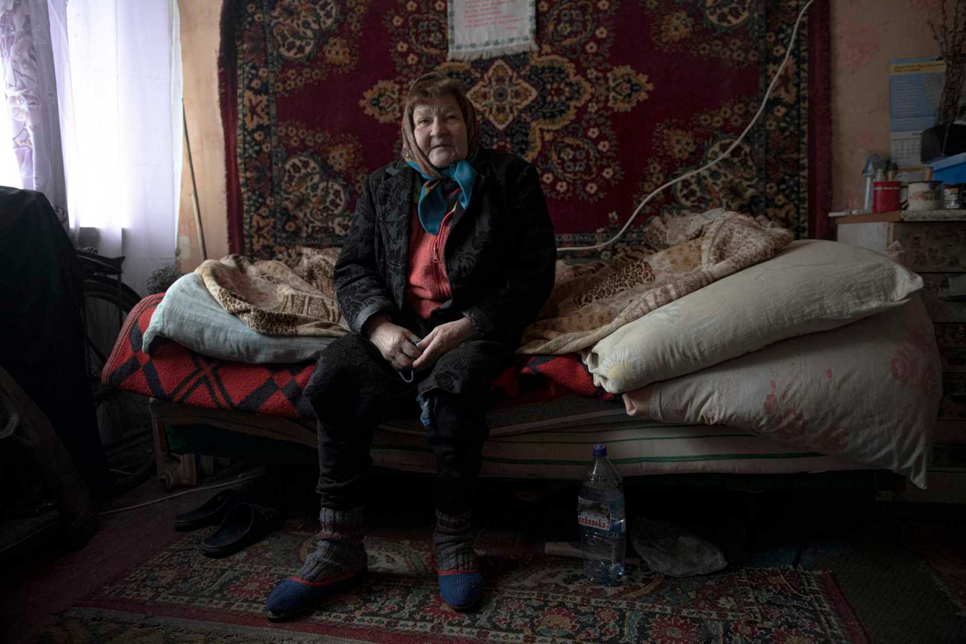 Hanna Reznikova, 63, in her room in bombed-out building in Borodyanka