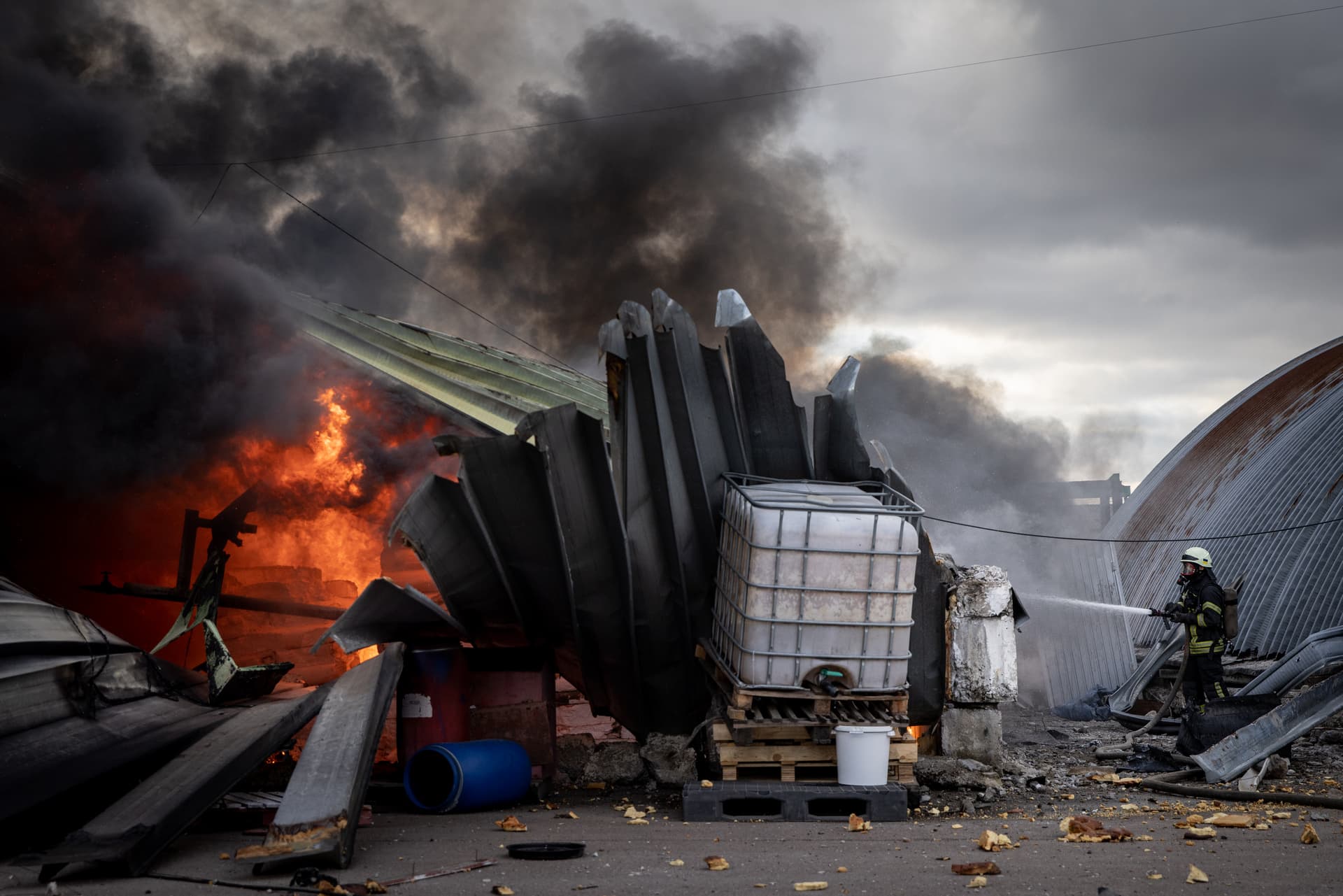 firefighter works to extinguish flames after a chemical warehouse near Kalynivka