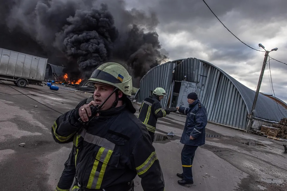 Firefighters attempt to put out a fire at a chemical warehouse that has come under fire in Brovary